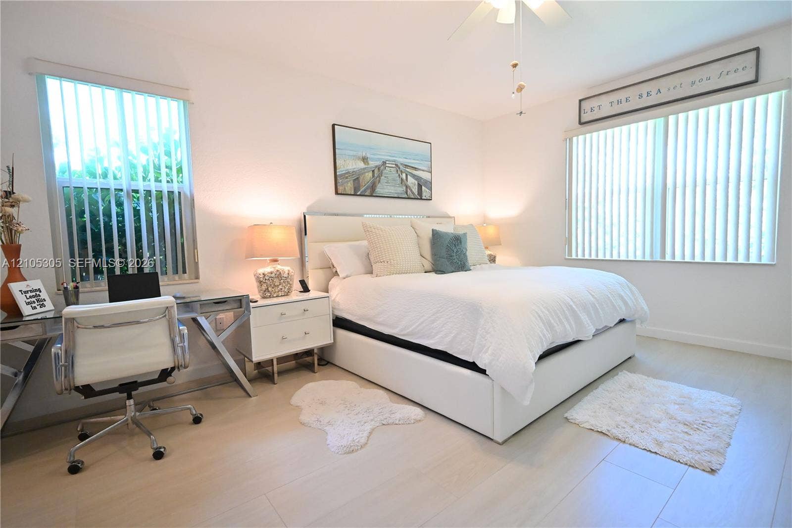 Recessed lighting, wood-finish flooring, ceiling fan, and multiple windows with vertical blinds