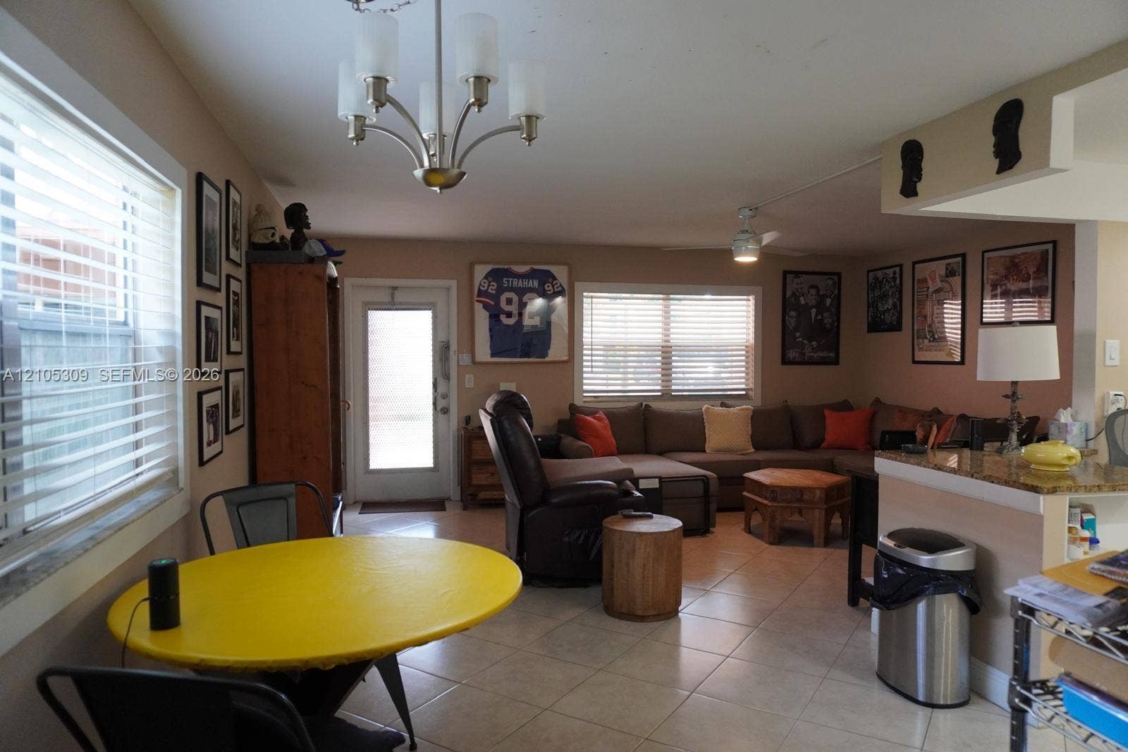 542 Saxony L, #542, Delray Beach, FL 33446 Tile flooring, multi-light chandelier, ceiling fan, and stone-surfaced kitchen peninsula