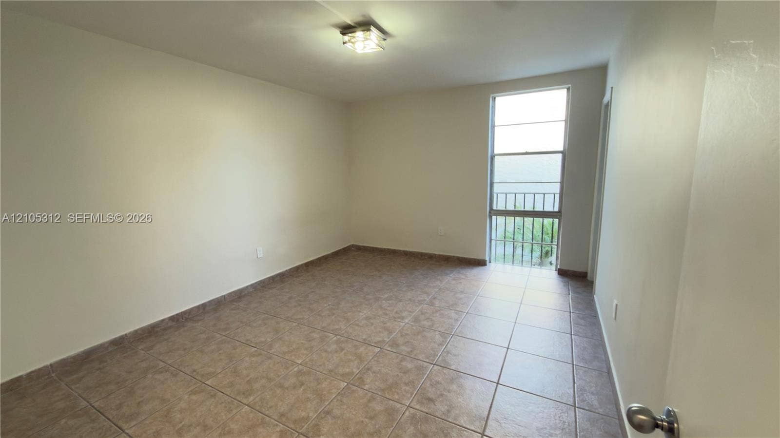 6900 N Kendall Drive, #A304, Pinecrest, Pinecrest, FL 33156 Room featuring neutral wall finishes, tile flooring, a large window, and an overhead lighting fixture