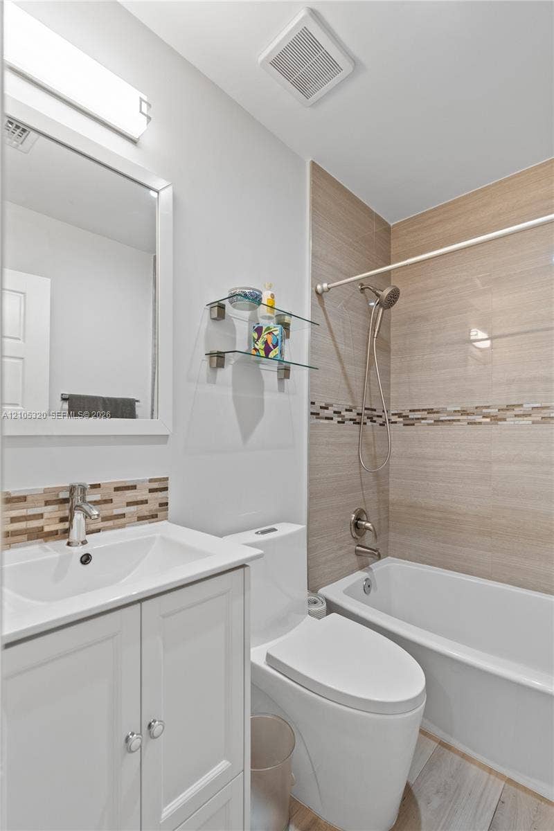 White vanity with chrome hardware, rectangular sink, and chrome faucet