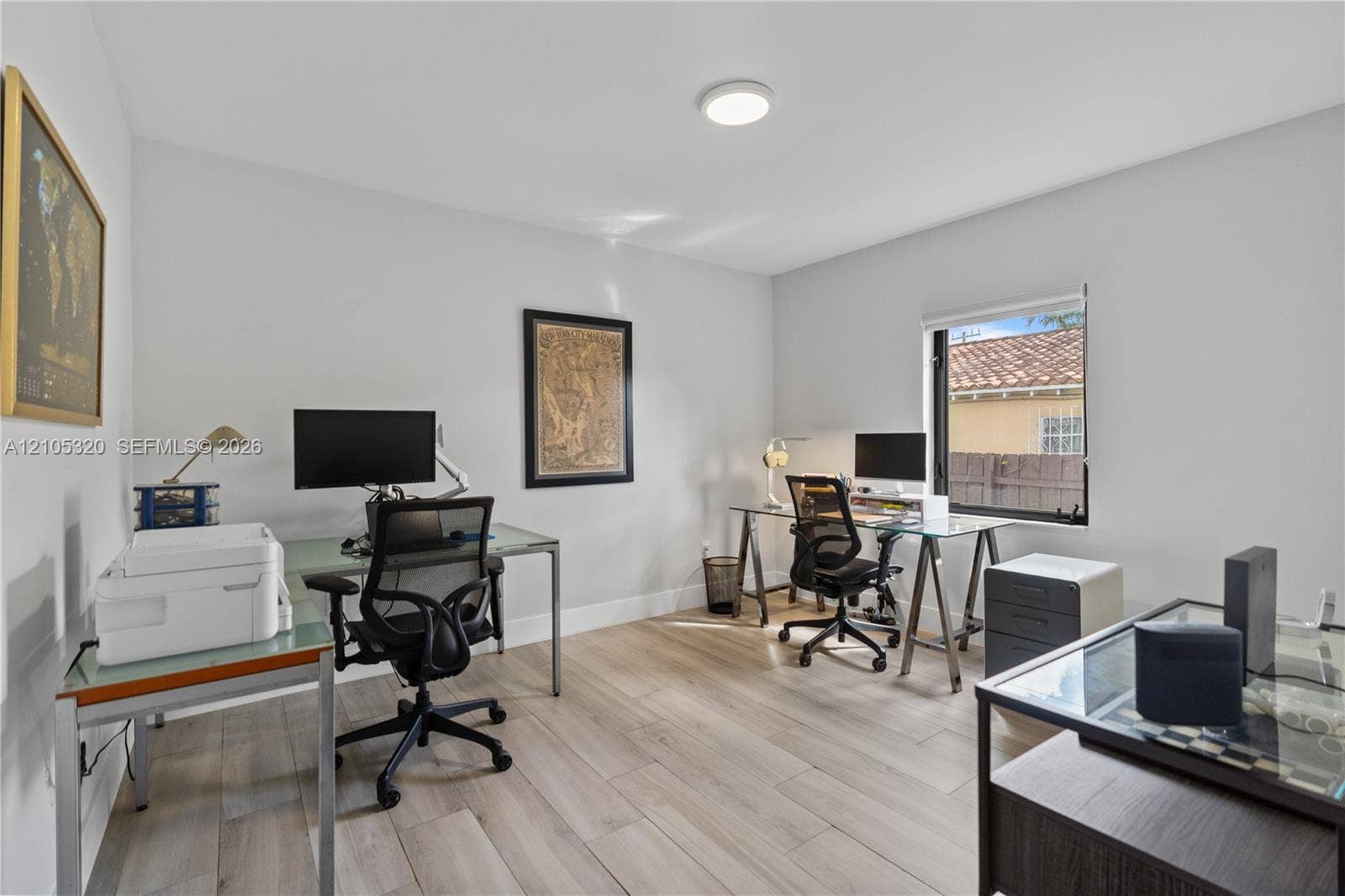 Neutral wall tones, wood-finish flooring, and a flush-mount ceiling light