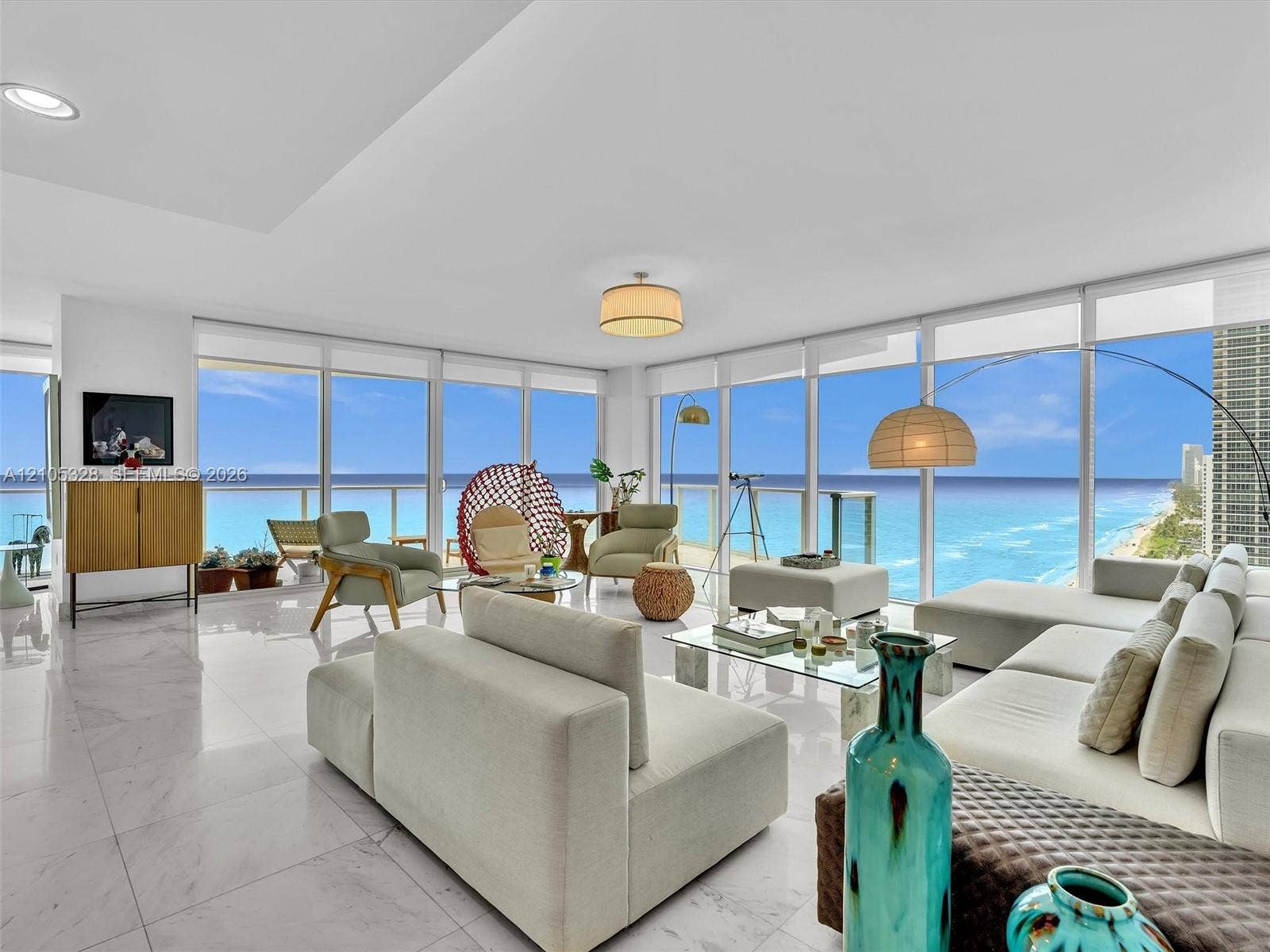3951 S Ocean Drive, #1901, Hollywood, FL 33019 Elegant living area featuring Carrara marble flooring, floor-to-ceiling windows, stunning ocean views, and recessed ceiling lighting.