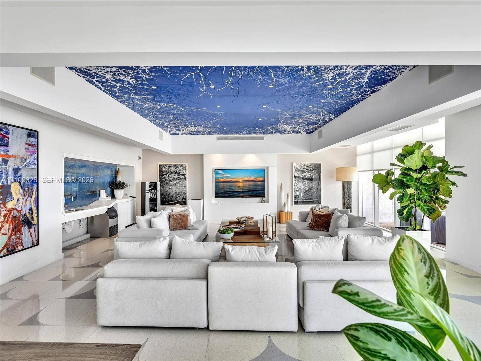 3951 S Ocean Drive, #1901, Hollywood, FL 33019 Elegant residents' lounge offering a sophisticated, boutique-style ambiance with artistic blue-and-white ceiling details, integrated speakers, illuminated display niches, and designer tile flooringa stylish space for residents to relax and socialize.