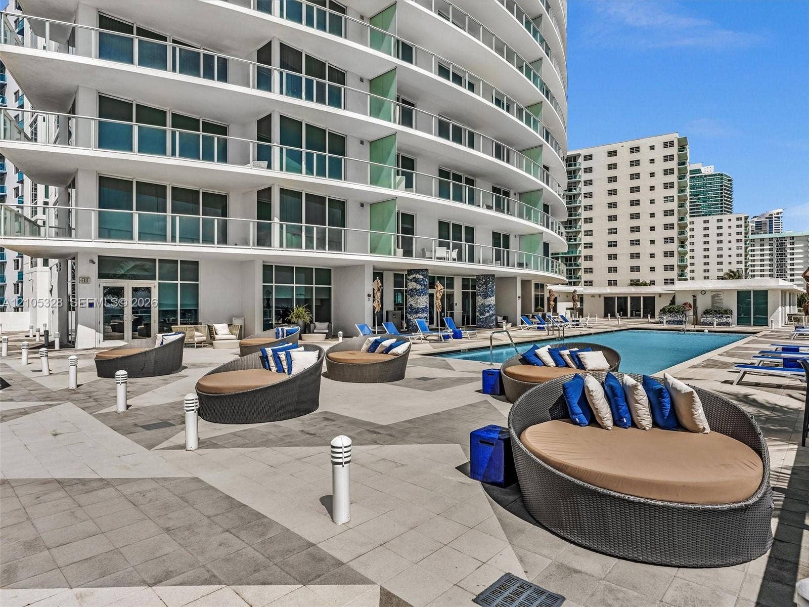 3951 S Ocean Drive, #1901, Hollywood, FL 33019 Experience oceanfront resort-style living at Apogee Beach, featuring an inviting swimming pool, expansive pool deck, sleek glass railings, and direct access to the beach and Atlantic Ocean.