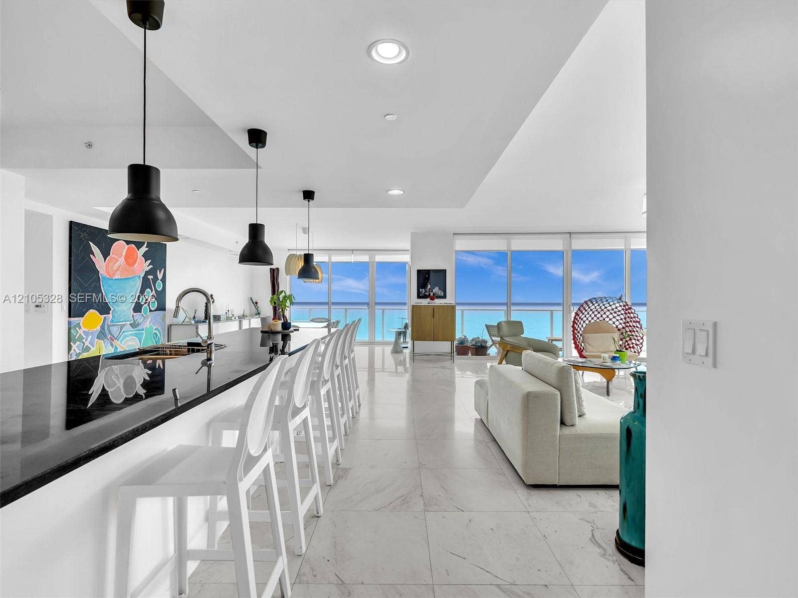 3951 S Ocean Drive, #1901, Hollywood, FL 33019 Expansive living area featuring elegant large-format marble-look tile flooring.