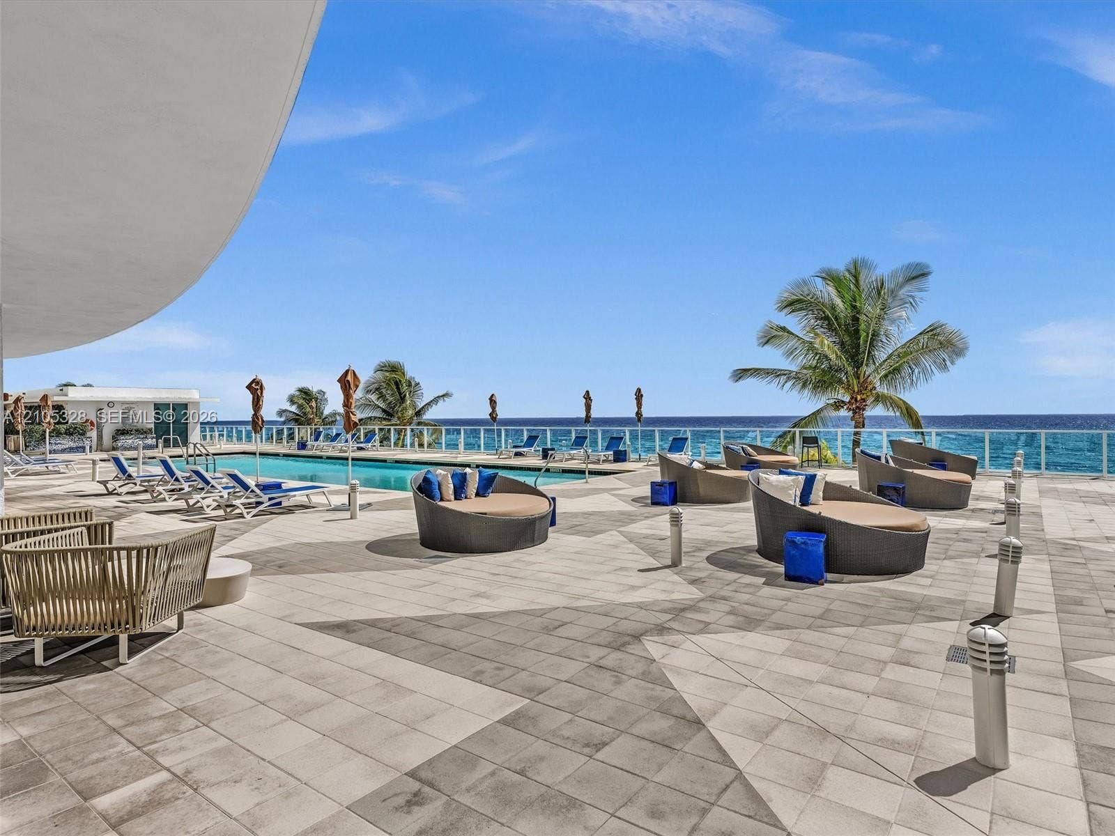 3951 S Ocean Drive, #1901, Hollywood, FL 33019 Experience oceanfront resort-style living at Apogee Beach, featuring an inviting swimming pool, expansive pool deck, sleek glass railings, and direct access to the beach and Atlantic Ocean.