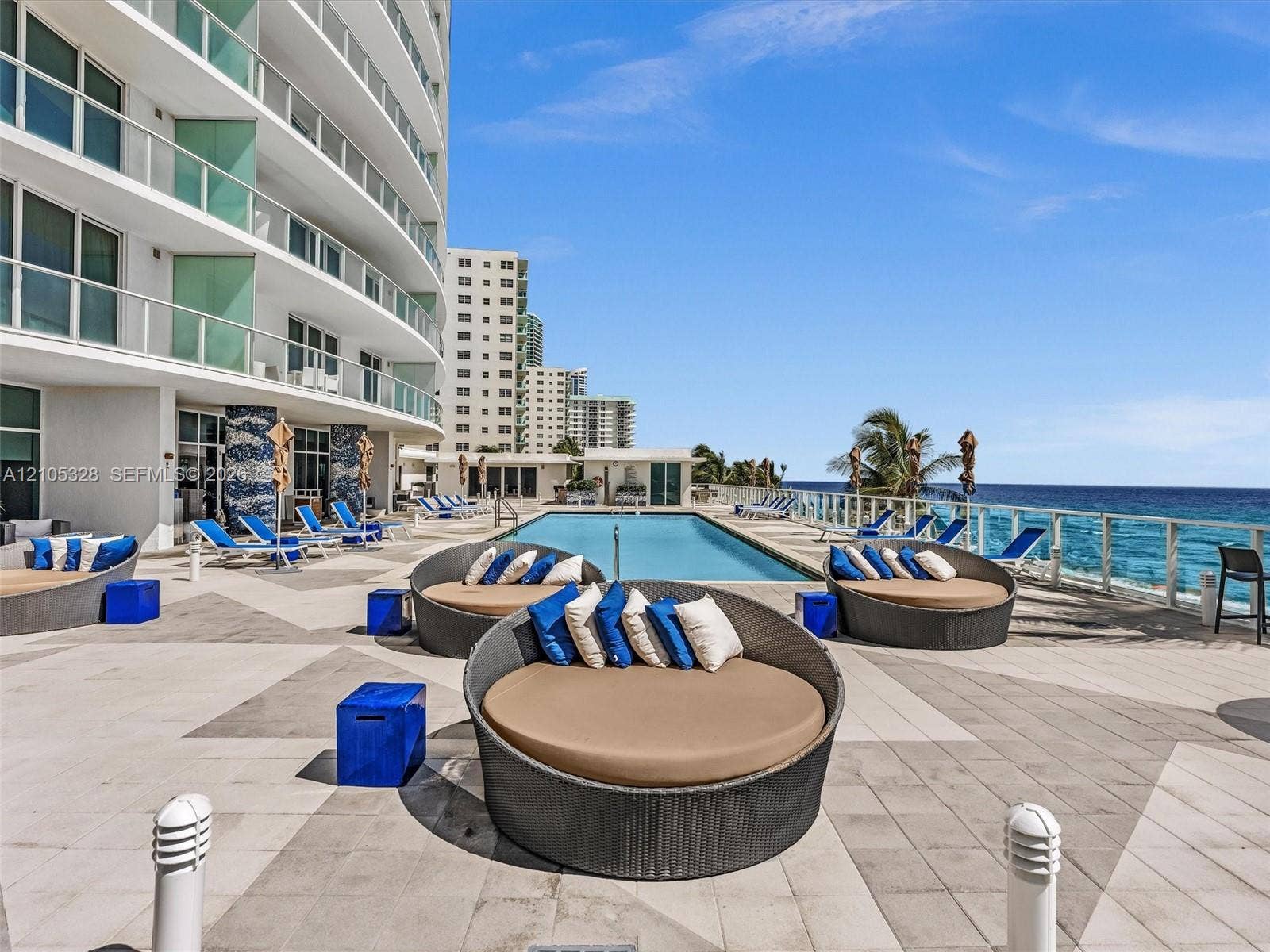 3951 S Ocean Drive, #1901, Hollywood, FL 33019 Experience oceanfront resort-style living at Apogee Beach, featuring an inviting swimming pool, expansive pool deck, sleek glass railings, and direct access to the beach and Atlantic Ocean.