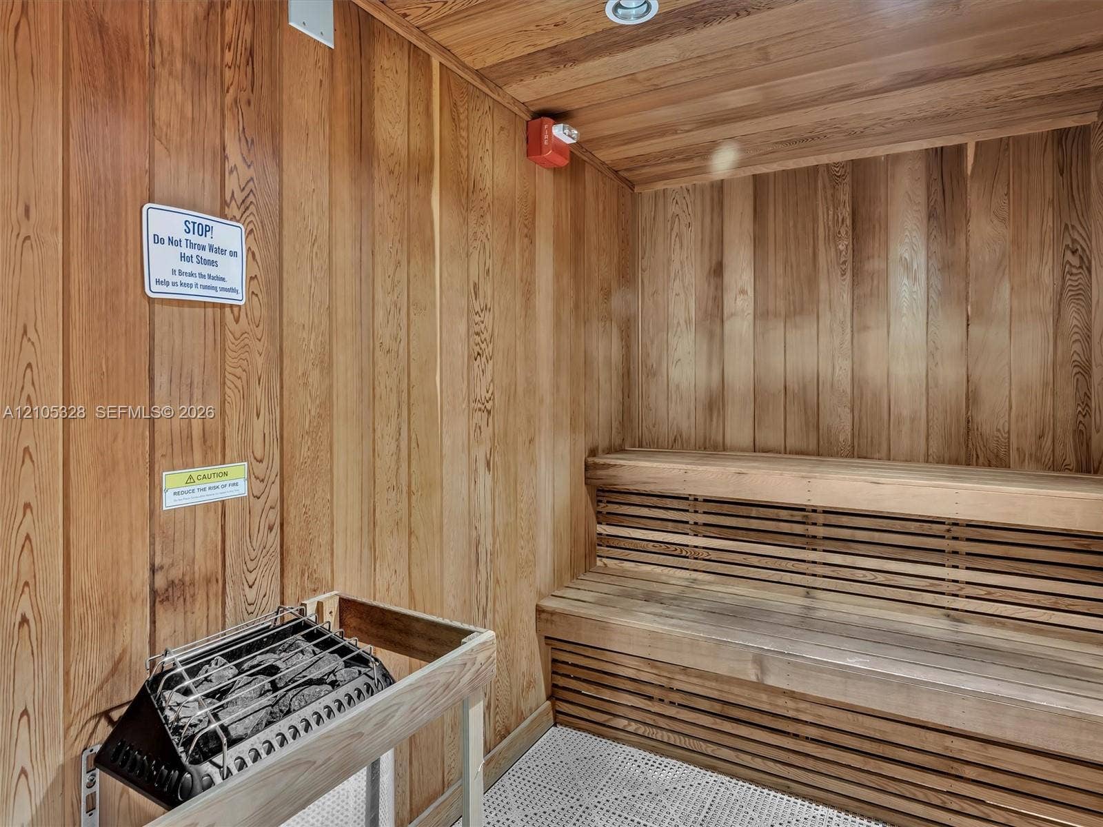 3951 S Ocean Drive, #1901, Hollywood, FL 33019 Wood-paneled sauna featuring built-in wood benches, a sauna heater with protective railing, and recessed ceiling lighting