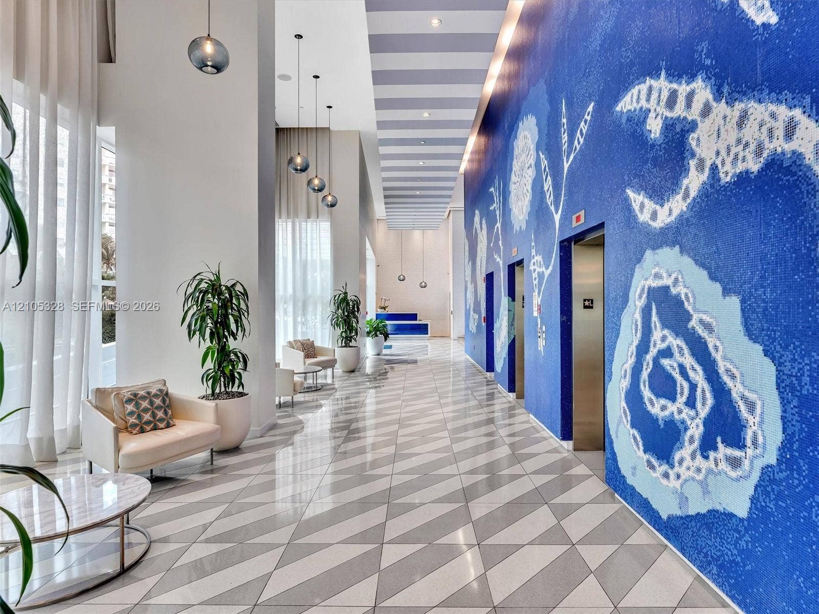 3951 S Ocean Drive, #1901, Hollywood, FL 33019 Step into an elegant, contemporary lobby with the intimate ambiance of a luxury boutique hotel, featuring distinctive designer finishes, stylish architectural details, sophisticated accent lighting, and a welcoming atmosphere.