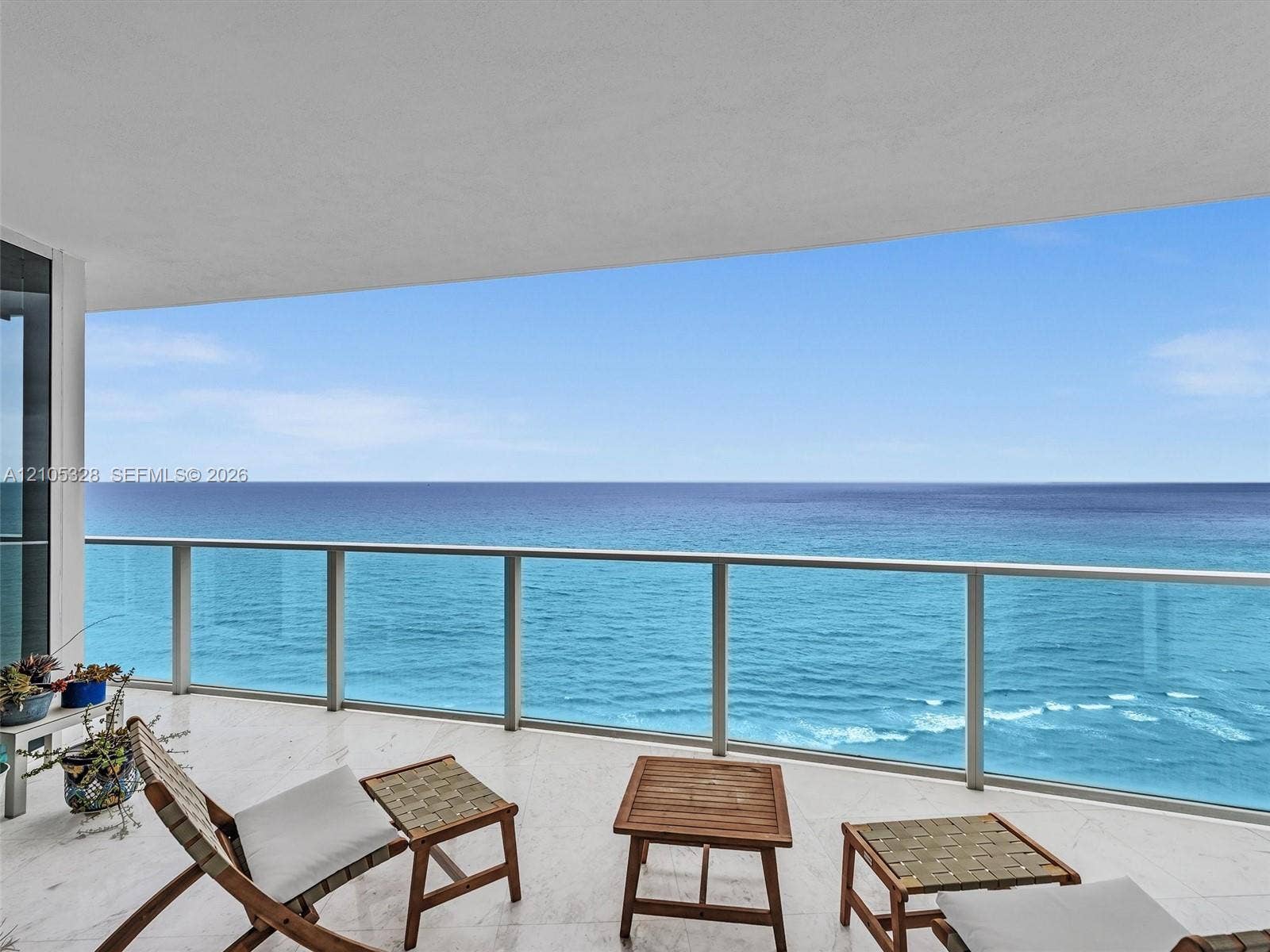 3951 S Ocean Drive, #1901, Hollywood, FL 33019 Expansive private balcony featuring glass railings and breathtaking, unobstructed panoramic ocean views.