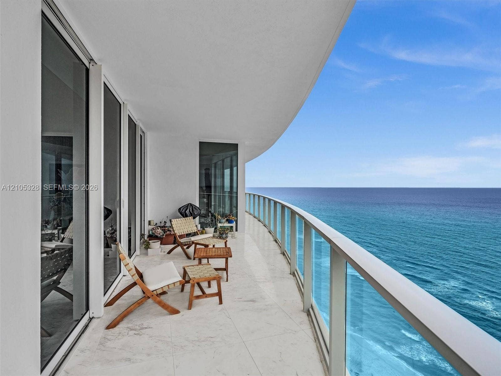 3951 S Ocean Drive, #1901, Hollywood, FL 33019 Expansive curved balcony with glass railings and panoramic ocean views.