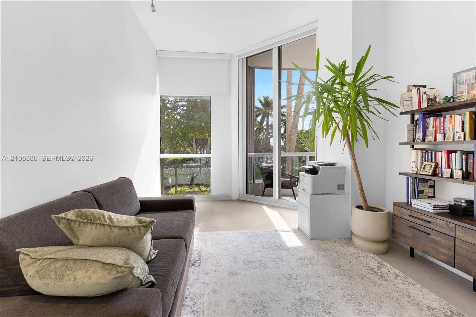21205 Yacht Club Drive, #304, Aventura, FL 33180 Full-height sliding glass doors, a corner window, and a built-in shelving unit