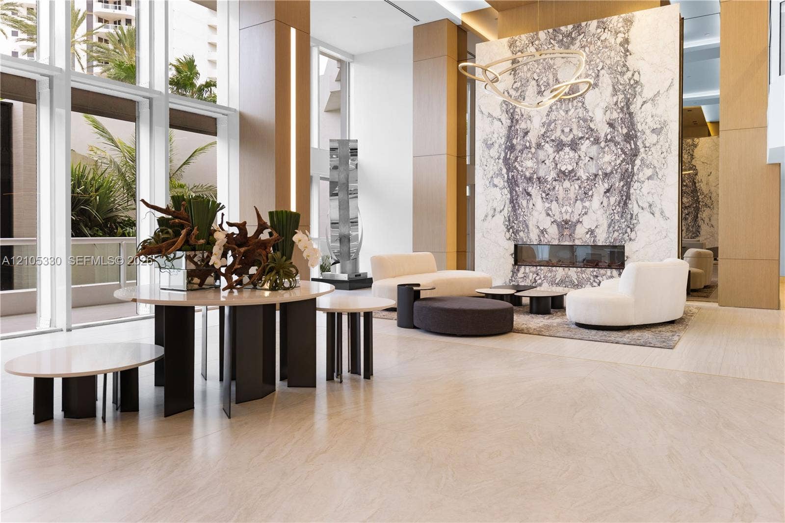 21205 Yacht Club Drive, #304, Aventura, FL 33180 Expansive floor-to-ceiling windows, large format tile flooring, stone accent wall with built-in linear fireplace, and integrated ceiling lighting