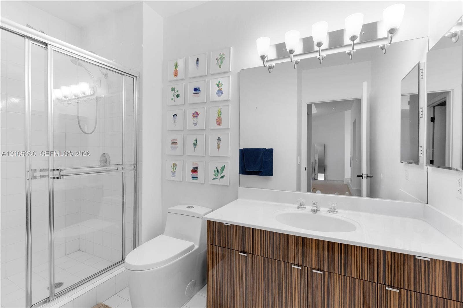 21205 Yacht Club Drive, #304, Aventura, FL 33180 Shower with glass enclosure, single vanity with wood-finish cabinetry, white countertop, and integrated sink