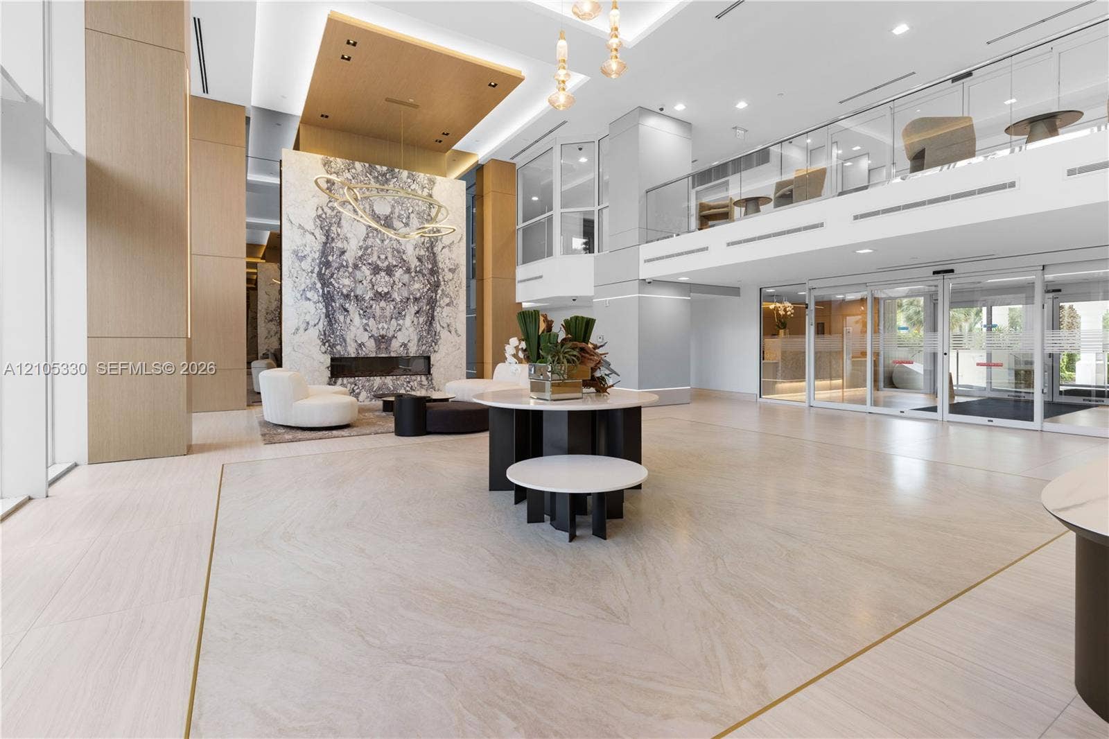 21205 Yacht Club Drive, #304, Aventura, FL 33180 Grand entryway featuring high ceilings, a built-in fireplace with a stone surround, and polished tile flooring