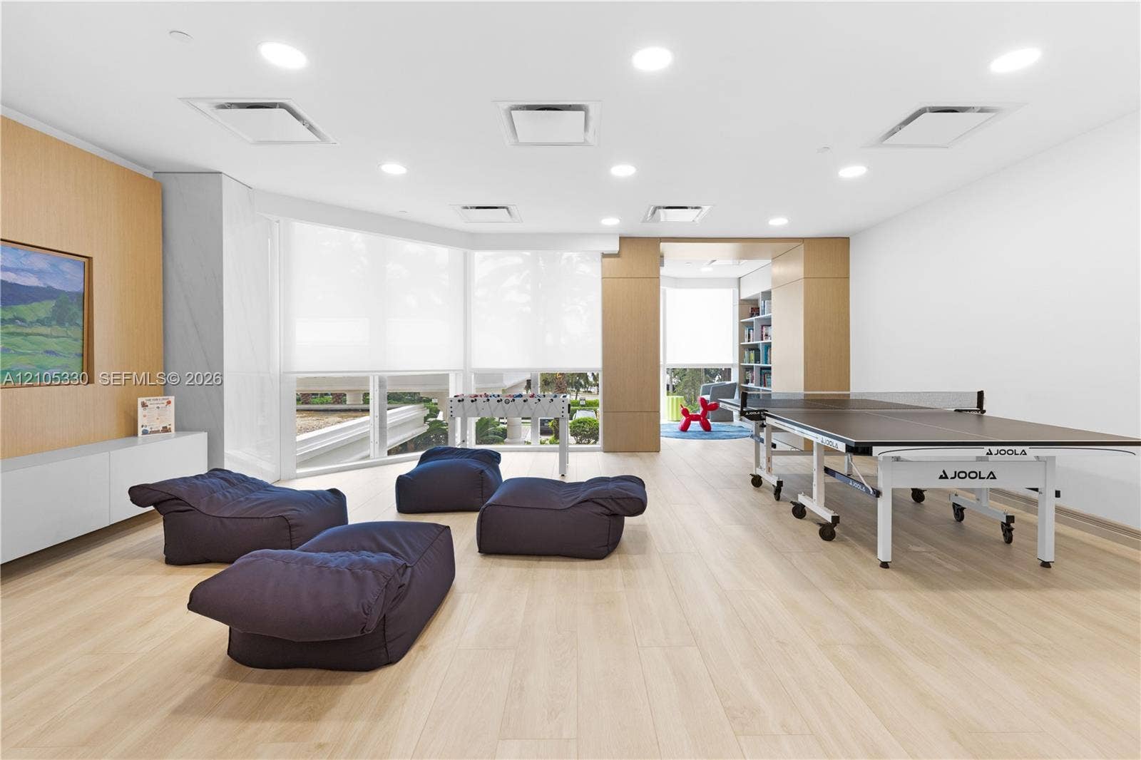 21205 Yacht Club Drive, #304, Aventura, FL 33180 Recessed ceiling lighting, light wood-finish flooring, built-in cabinetry, and expansive windows with roller shades
