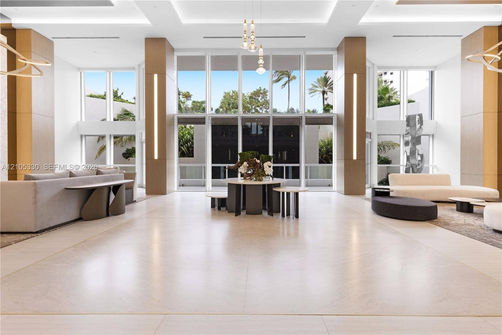 21205 Yacht Club Drive, #304, Aventura, FL 33180 Spacious common area featuring large format tile flooring, extensive floor-to-ceiling windows, and recessed ceiling lighting