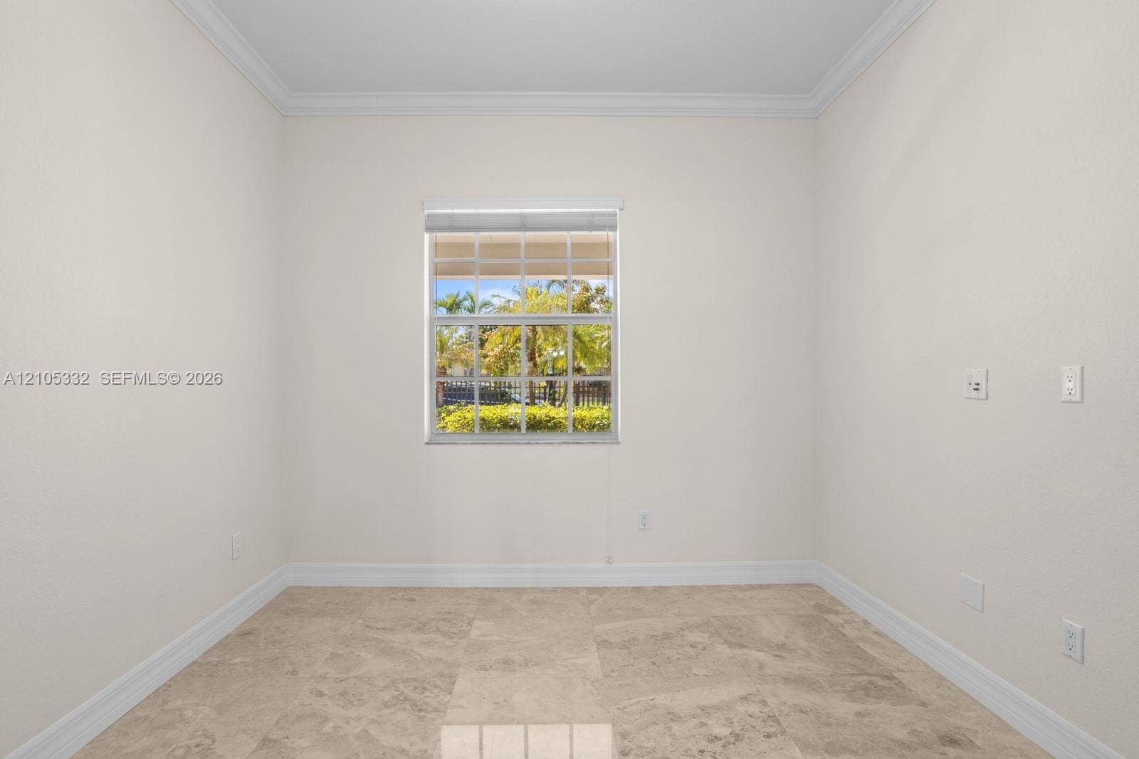Neutral wall paint, crown molding, a single window with blinds, and tile flooring