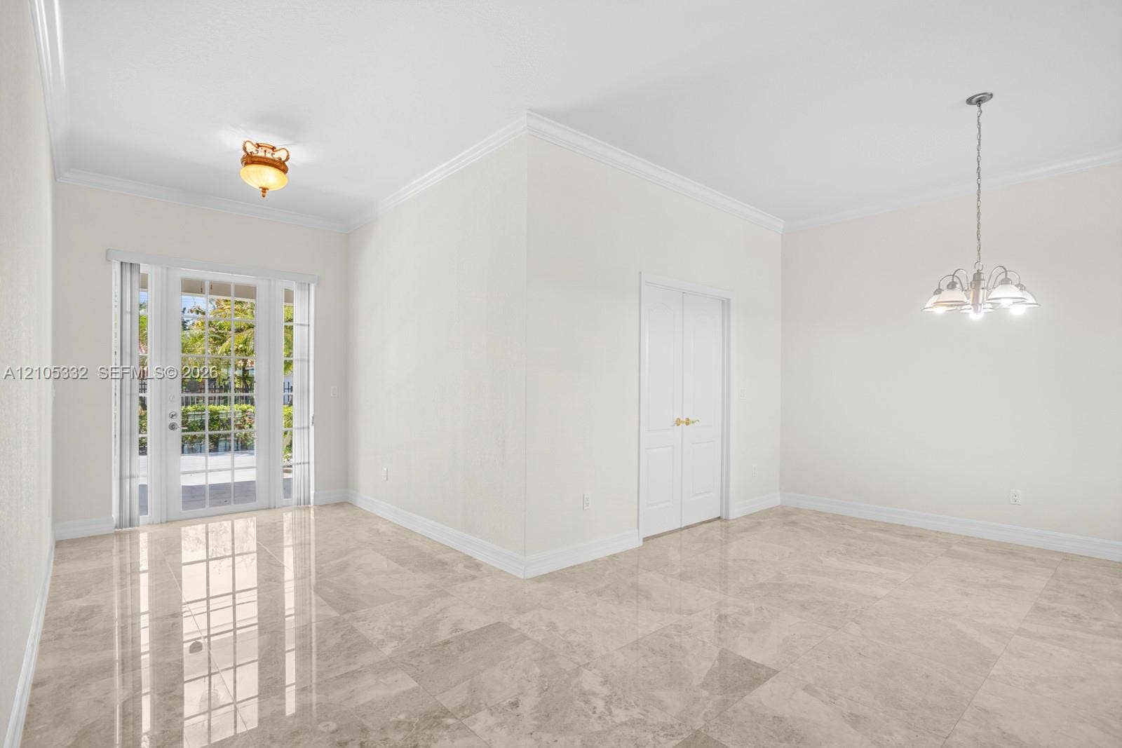 Polished tile flooring, crown molding, French doors, recessed lighting, and a modern chandelier