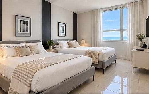 Expansive window offering ocean scenery, bright white walls, dark accent wall, and polished tile flooring