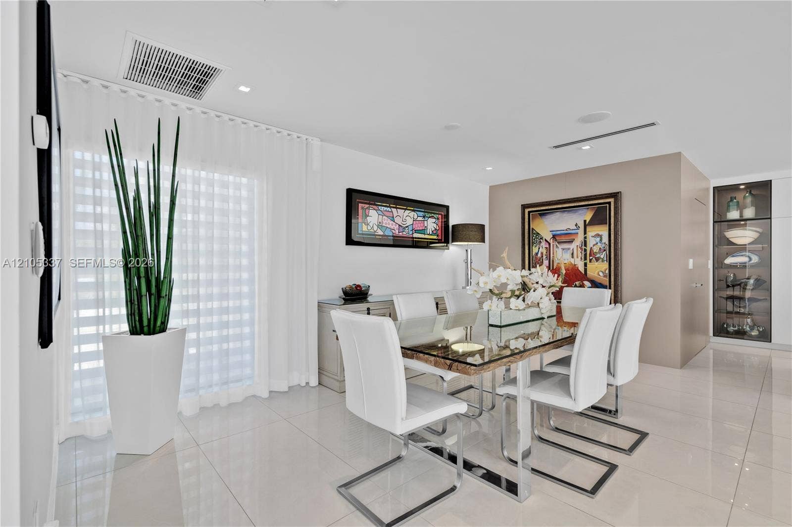 3322 NE 166th Street, North Miami Beach, FL 33160 Large-format tile flooring, recessed ceiling lighting, and built-in glass-front display cabinetry