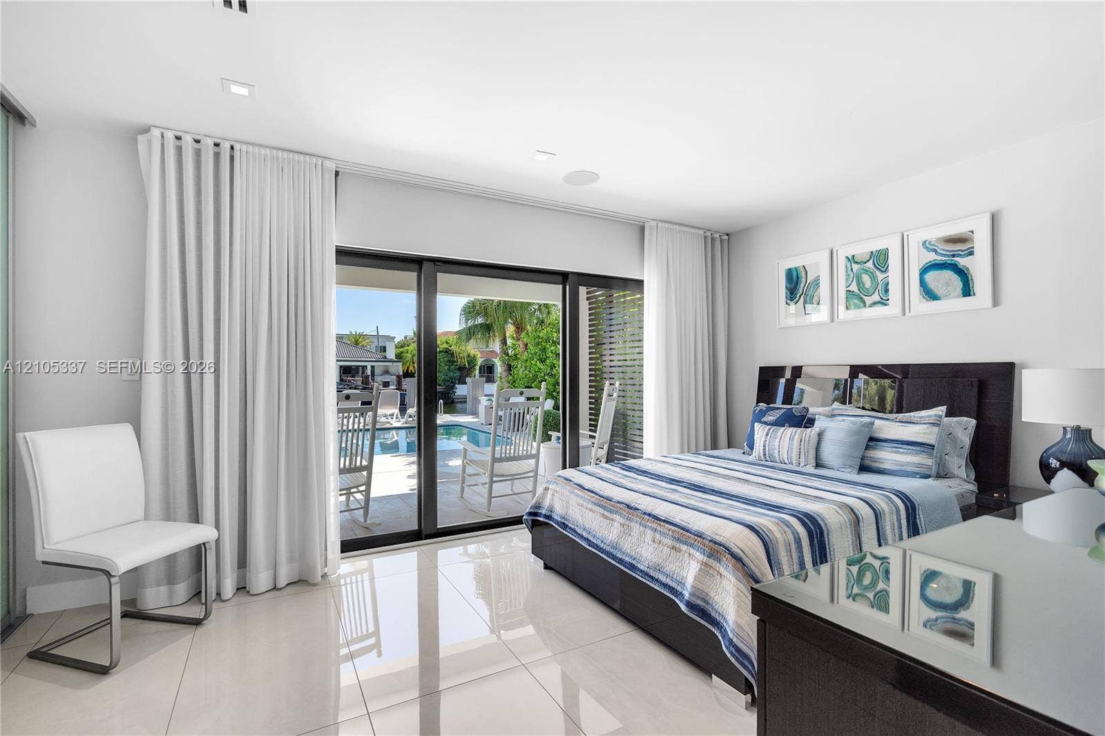 3322 NE 166th Street, North Miami Beach, FL 33160 Large-format porcelain tile flooring, sliding glass door system, and recessed ceiling lighting
