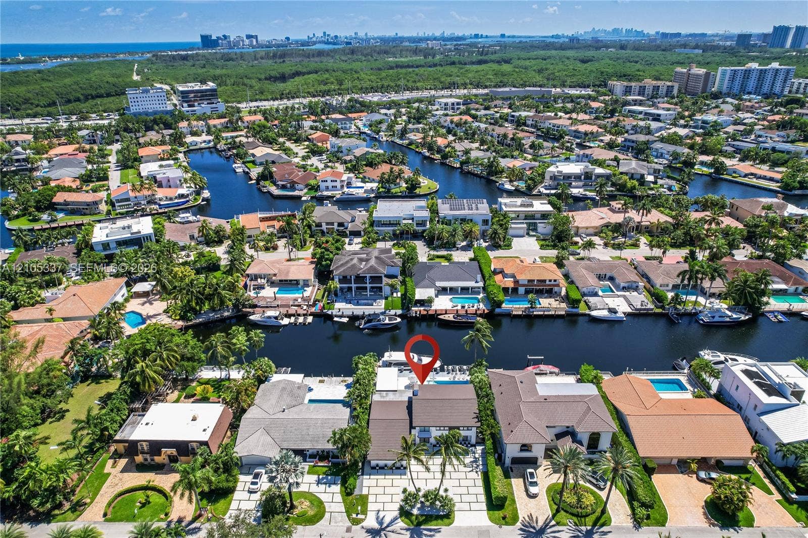 3322 NE 166th Street, North Miami Beach, FL 33160 Waterfront property featuring a private boat dock, swimming pool, and paver driveway