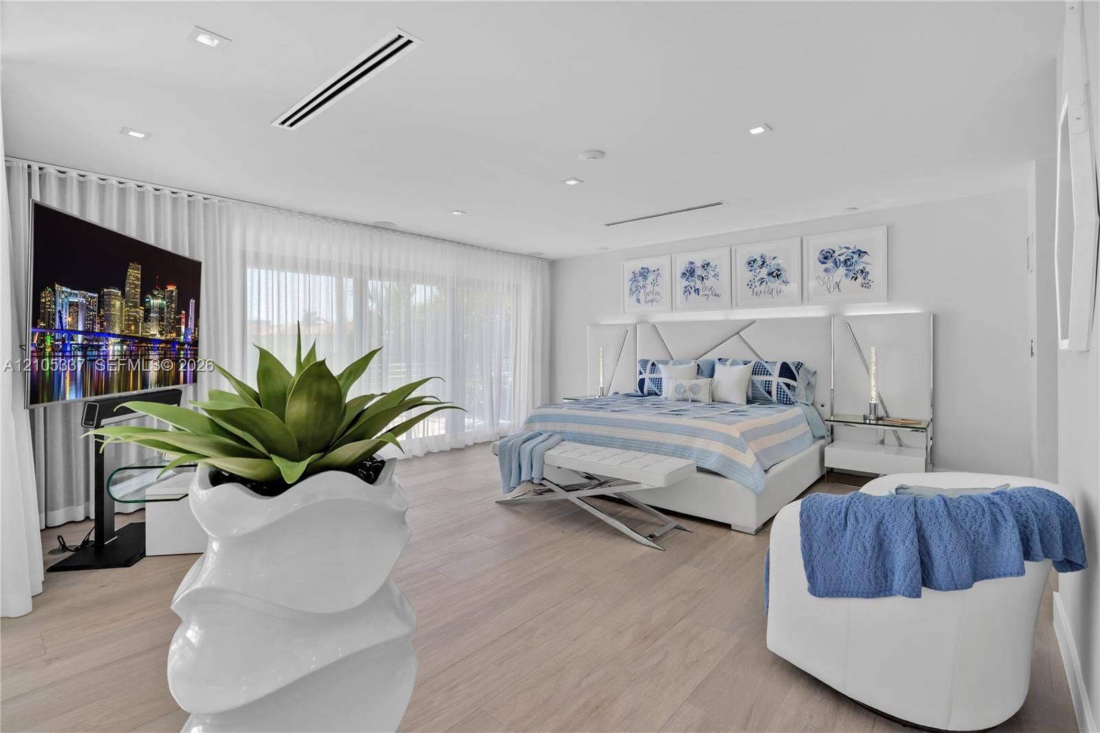 3322 NE 166th Street, North Miami Beach, FL 33160 Wood-finish flooring, recessed lighting, integrated linear ceiling registers, and expansive wall-to-wall sliding glass doors