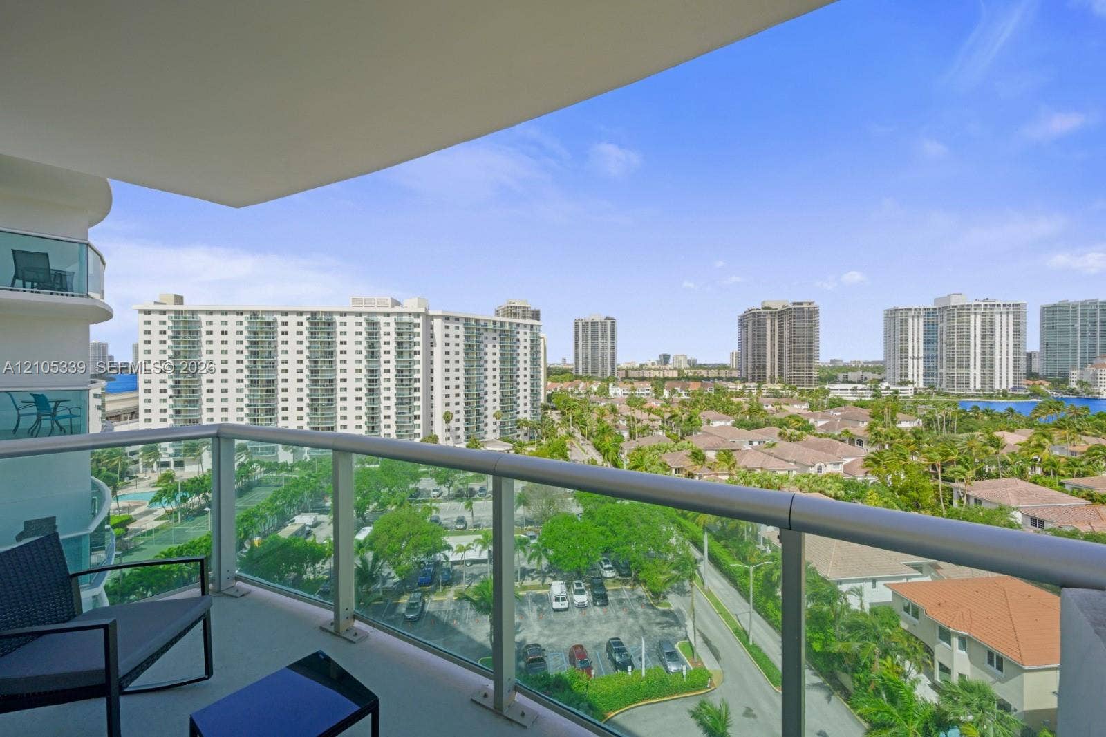 Expansive balcony with glass railings and city scenery