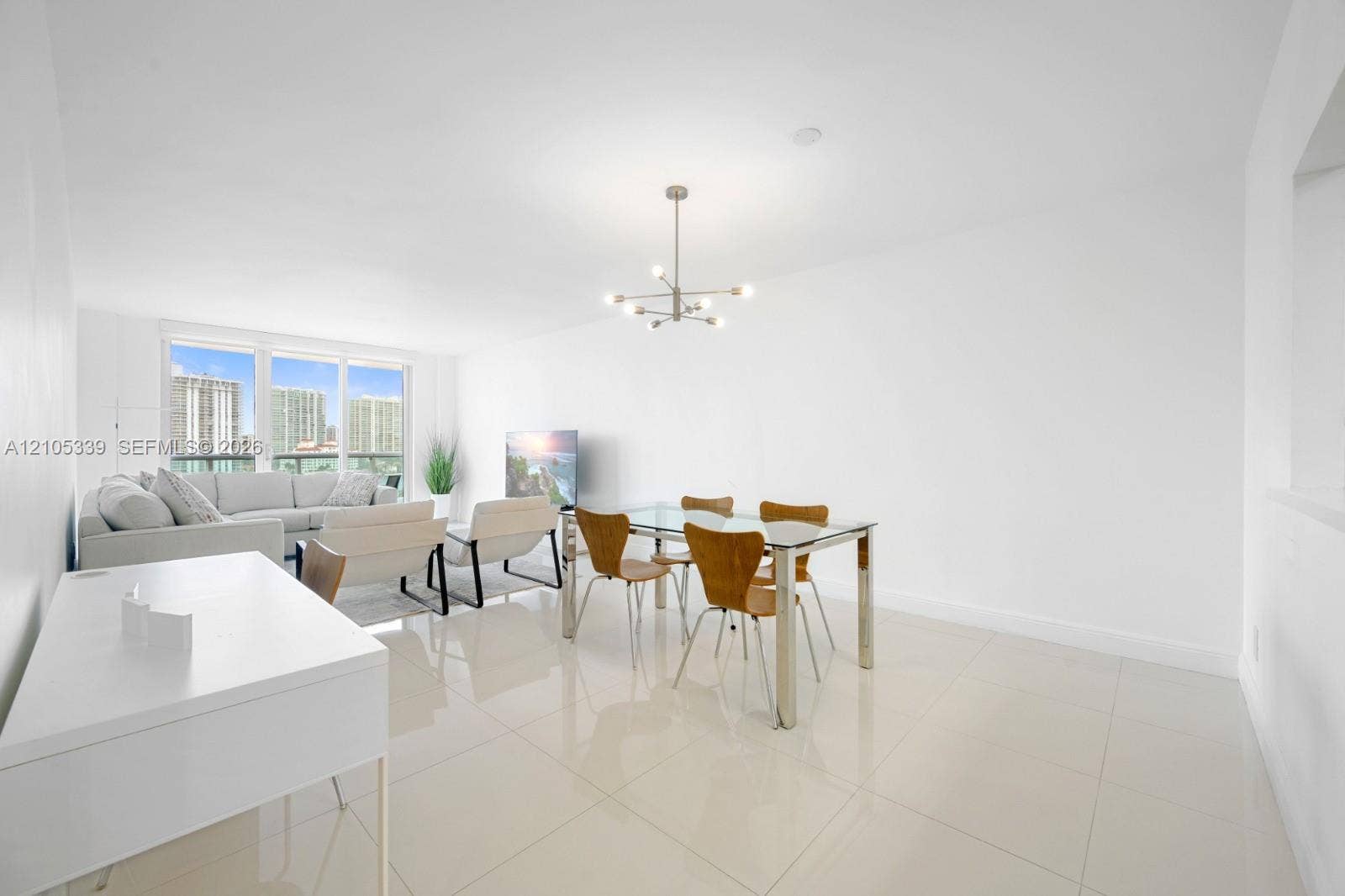 Glossy tile flooring, contemporary chandelier, full-height windows, recessed lighting, and a built-in wall niche