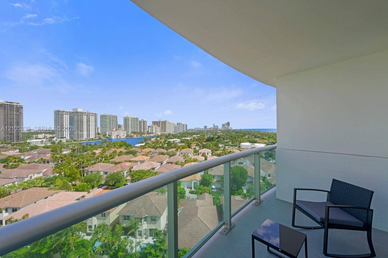 Expansive balcony featuring a glass railing system and concrete flooring