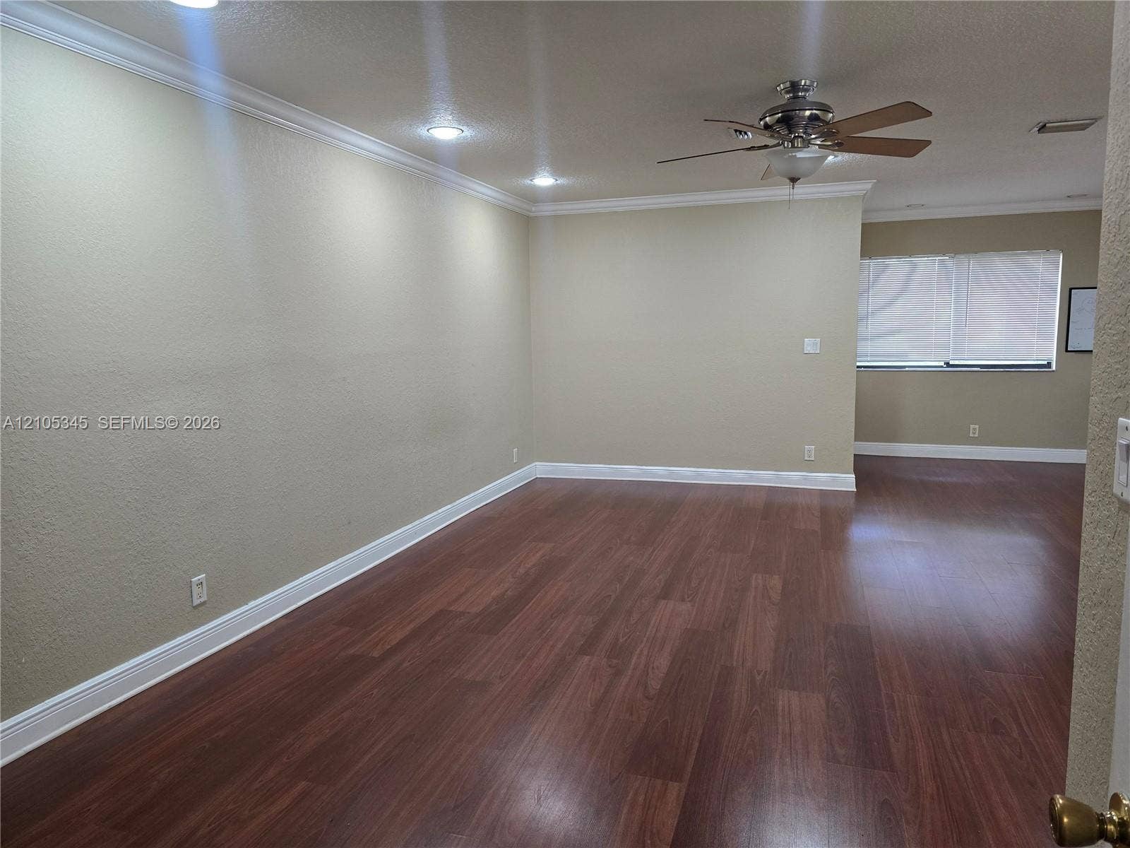 Interior featuring wood-finish flooring, recessed lighting, crown molding, and a ceiling fan