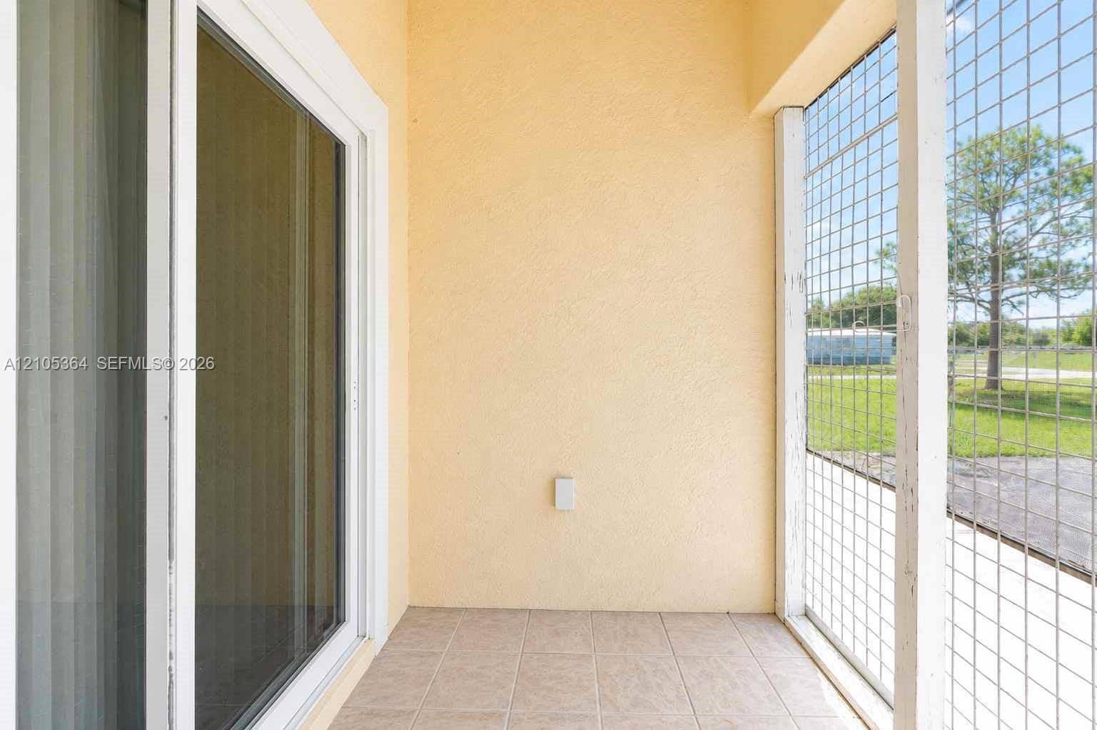 Screened patio with ceramic tile flooring and textured stucco walls