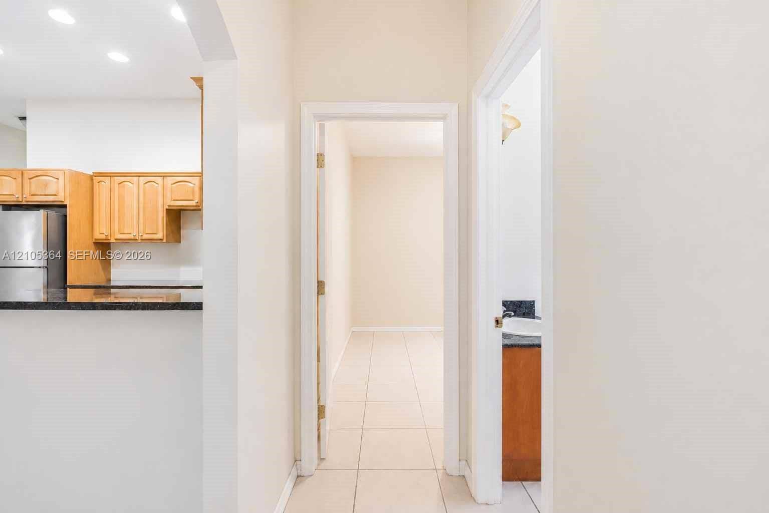 Kitchen with wood cabinetry and stainless steel refrigerator