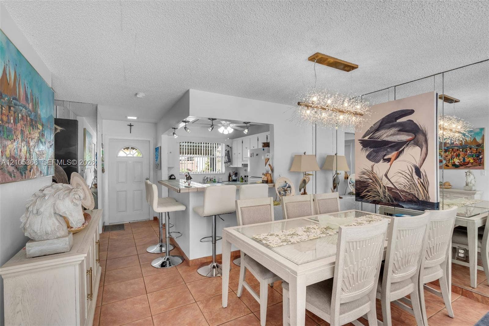 Tiled flooring throughout, white interior walls, and a built-in breakfast bar