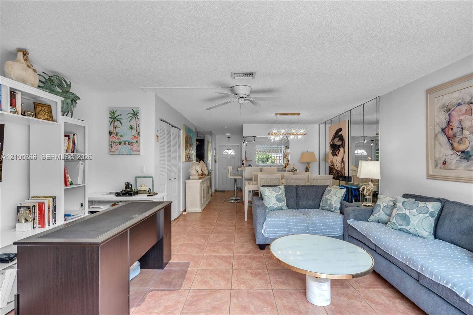 Terracotta tile flooring throughout with white walls and built-in shelving