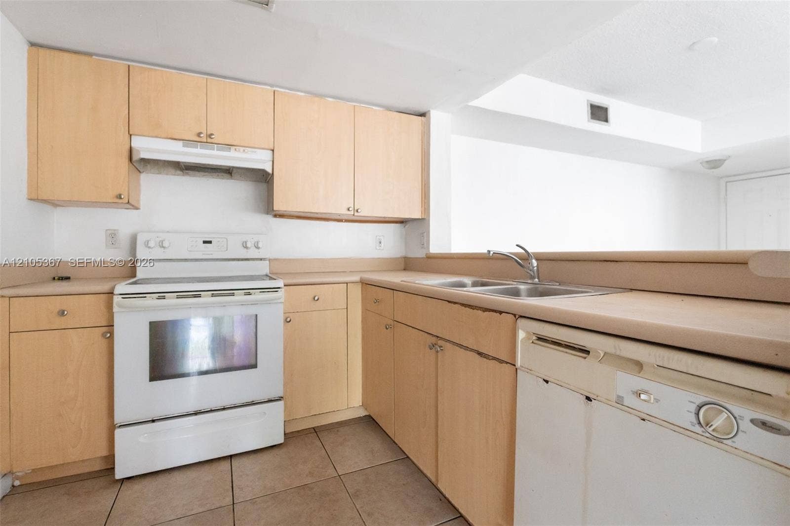 9066 W Atlantic Boulevard, #412, Coral Springs, FL 33071 Kitchen featuring light-finish cabinetry, a white electric range, an integrated range hood, a stainless steel double-basin sink, and tile flooring