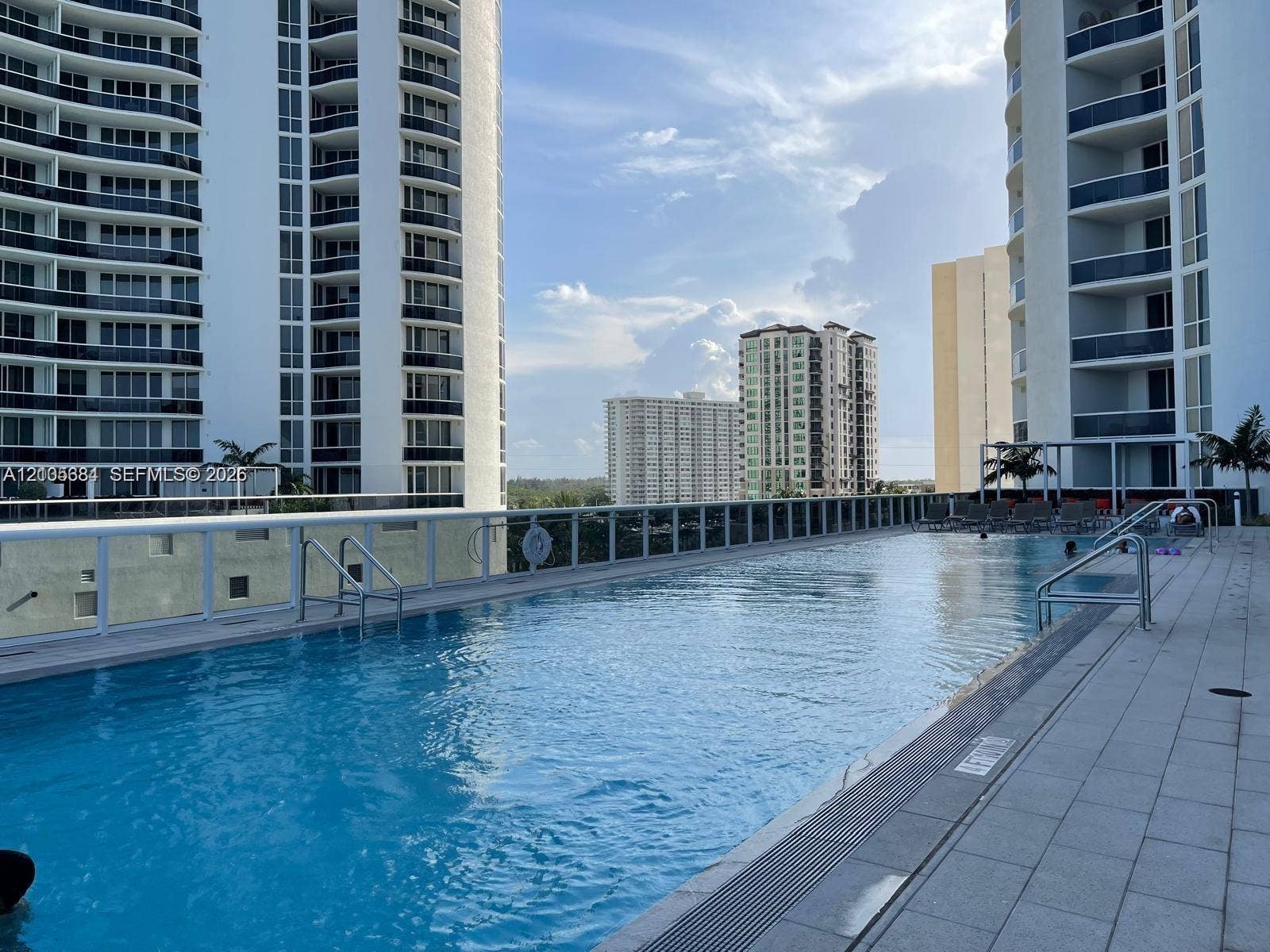 16001 Collins Avenue, #2803, Sunny Isles Beach, Sunny Isles Beach, FL 33160 Rooftop swimming pool with surrounding tile decking and clear panel railing