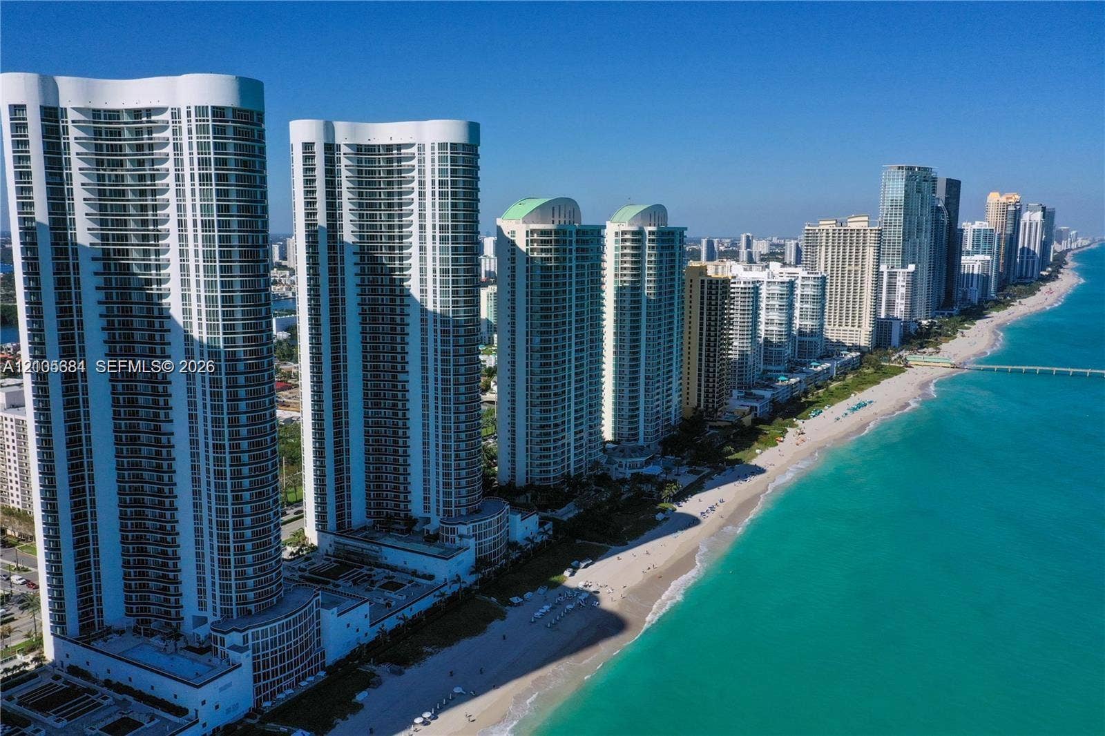 16001 Collins Avenue, #2803, Sunny Isles Beach, Sunny Isles Beach, FL 33160 Coastal high-rise residences with private balconies, set along a sandy beach and turquoise waters