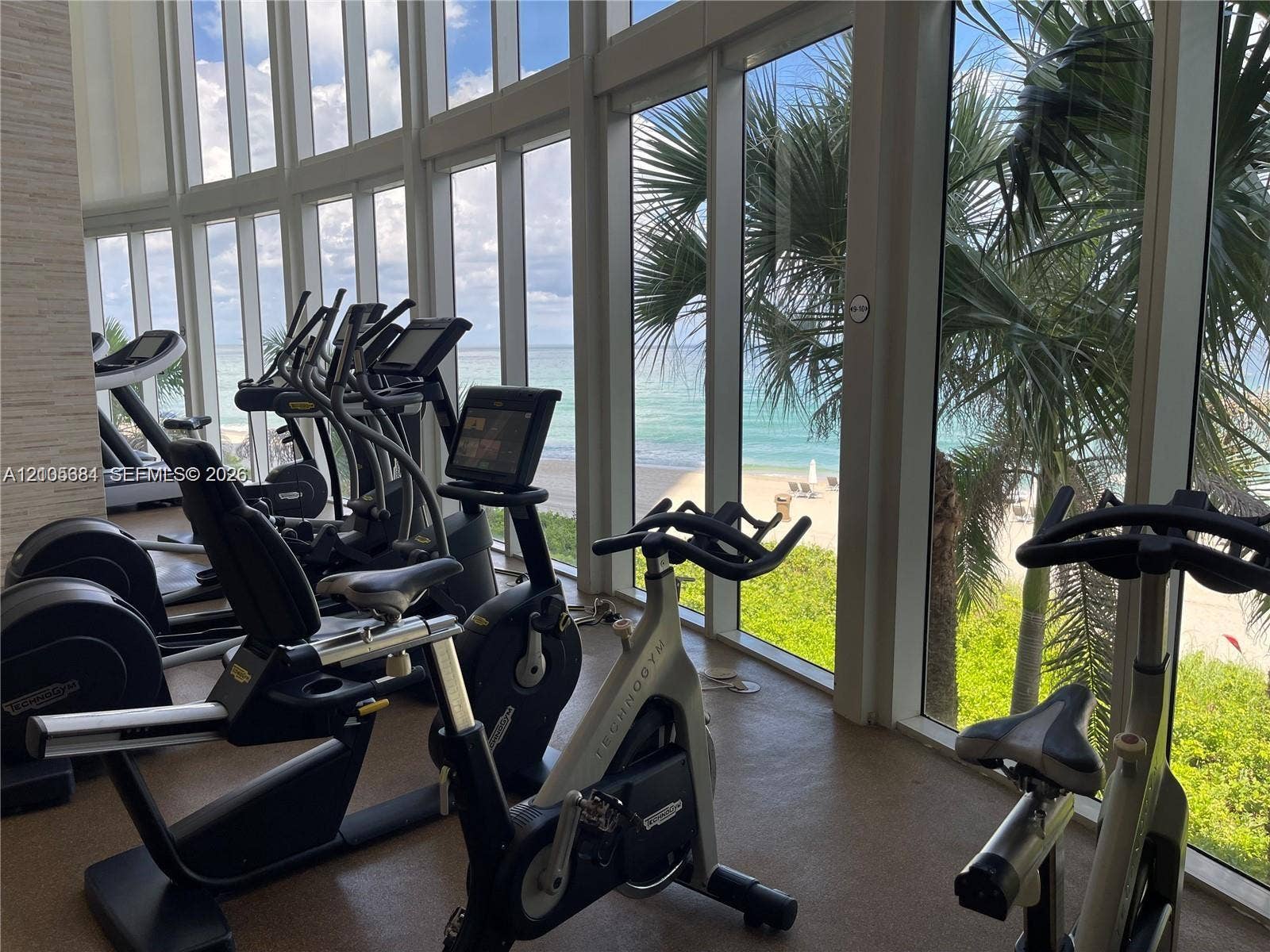 16001 Collins Avenue, #2803, Sunny Isles Beach, Sunny Isles Beach, FL 33160 Fitness center featuring a selection of cardio equipment, full-height windows, and ocean scenery
