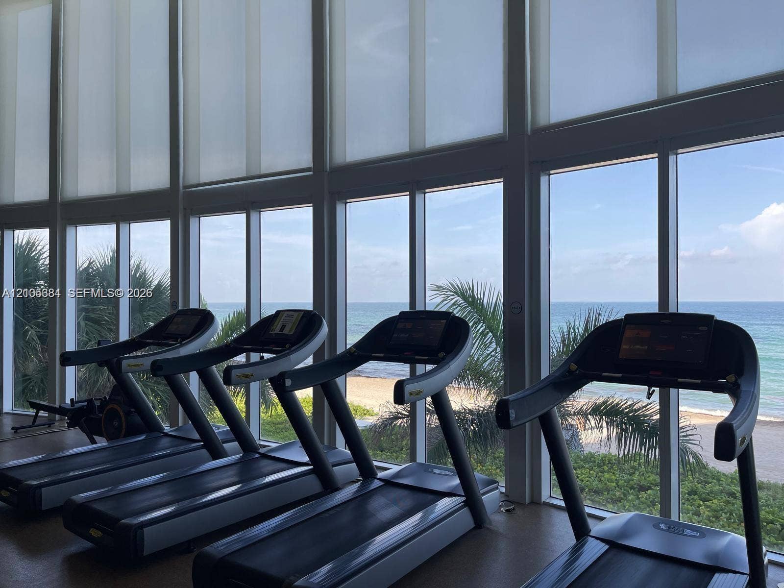 16001 Collins Avenue, #2803, Sunny Isles Beach, Sunny Isles Beach, FL 33160 Floor-to-ceiling windows with roller shades, a scenic ocean backdrop, and integrated fitness equipment