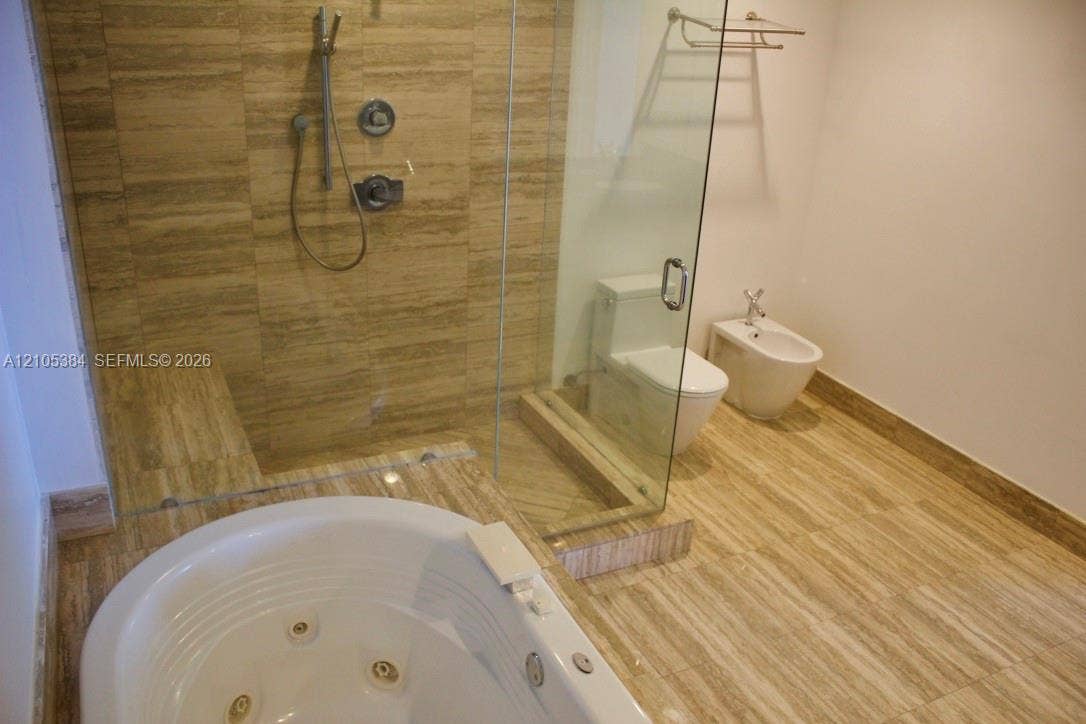 16001 Collins Avenue, #2803, Sunny Isles Beach, Sunny Isles Beach, FL 33160 Walk-in shower with natural stone tile, glass enclosure, and built-in bench