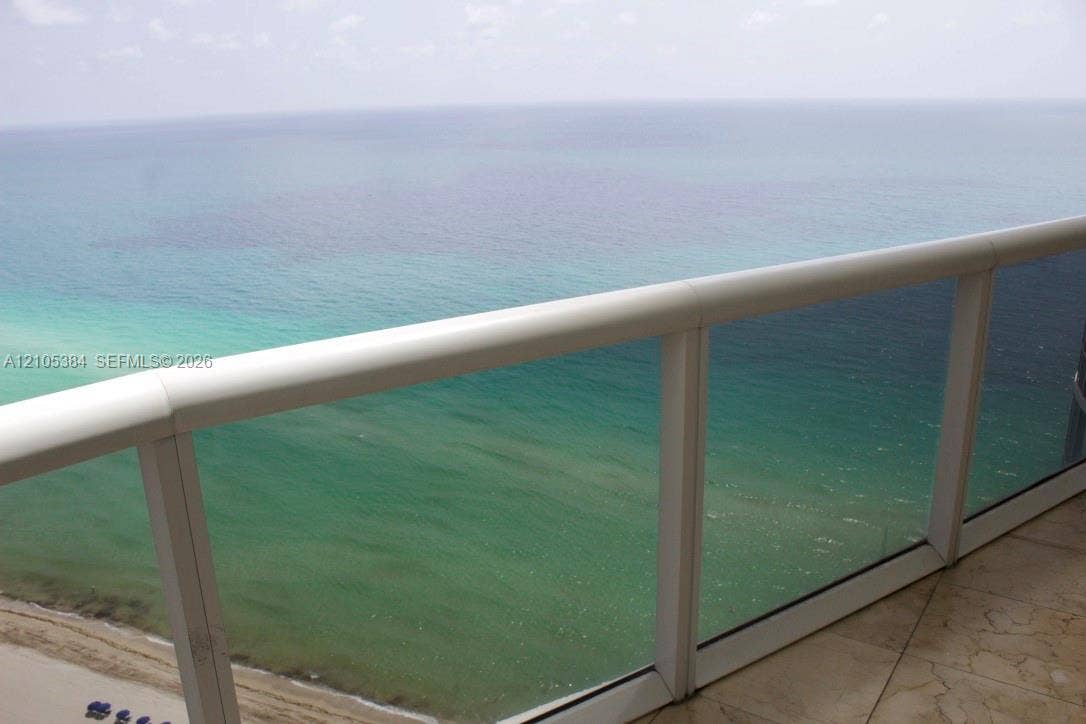 16001 Collins Avenue, #2803, Sunny Isles Beach, Sunny Isles Beach, FL 33160 Balcony featuring a glass railing system, white handrail, and tile flooring