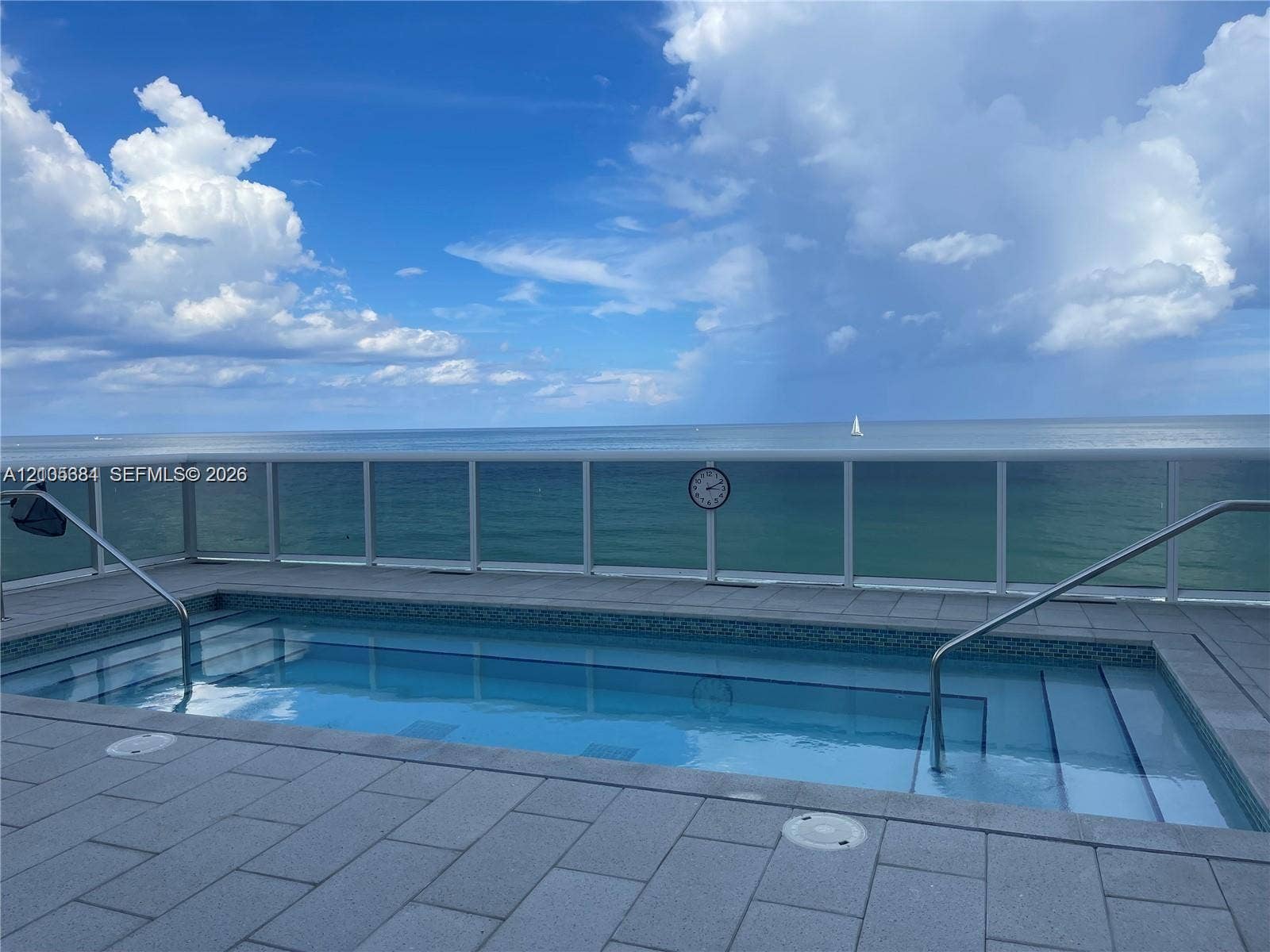 16001 Collins Avenue, #2803, Sunny Isles Beach, Sunny Isles Beach, FL 33160 Private pool with integrated steps, surrounded by paver decking and a clear panel railing, all overlooking the ocean