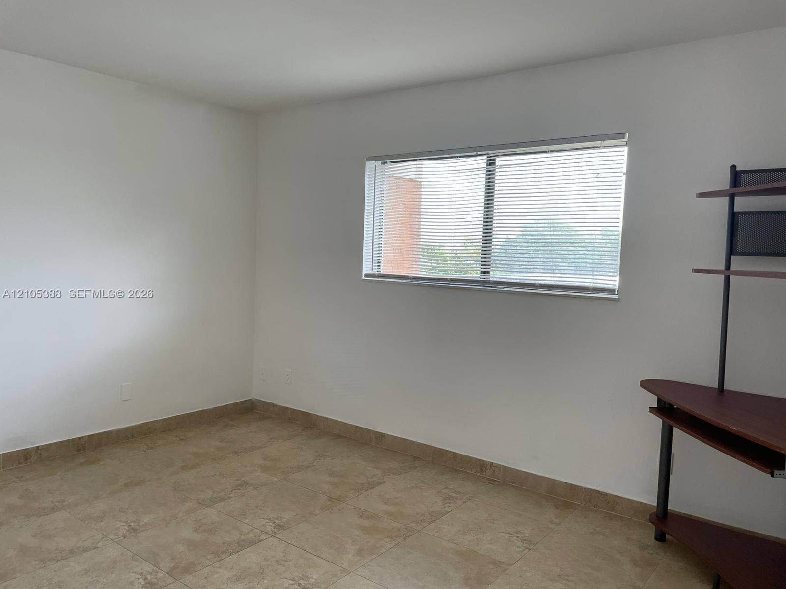 Neutral wall color with tile flooring and natural light