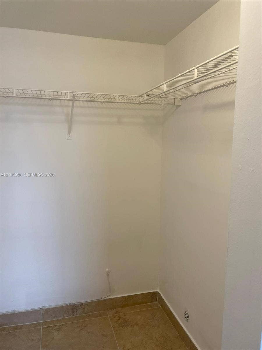 White wire shelving system, light-colored tile flooring, and neutral wall tones
