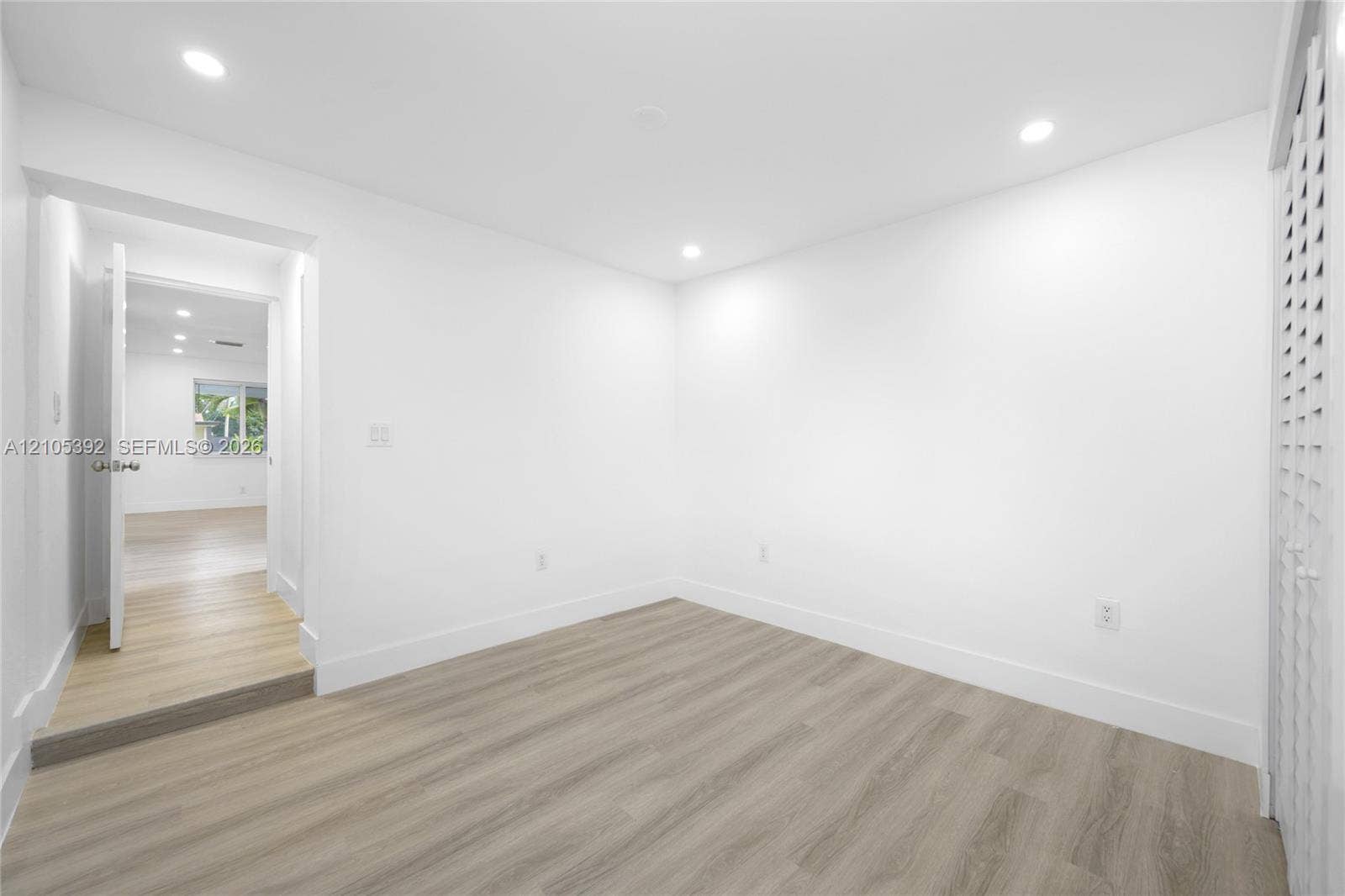 3197 Cleveland Street, Hollywood, FL 33021 Recessed lighting, wood-finish flooring, white walls, and a louvered door