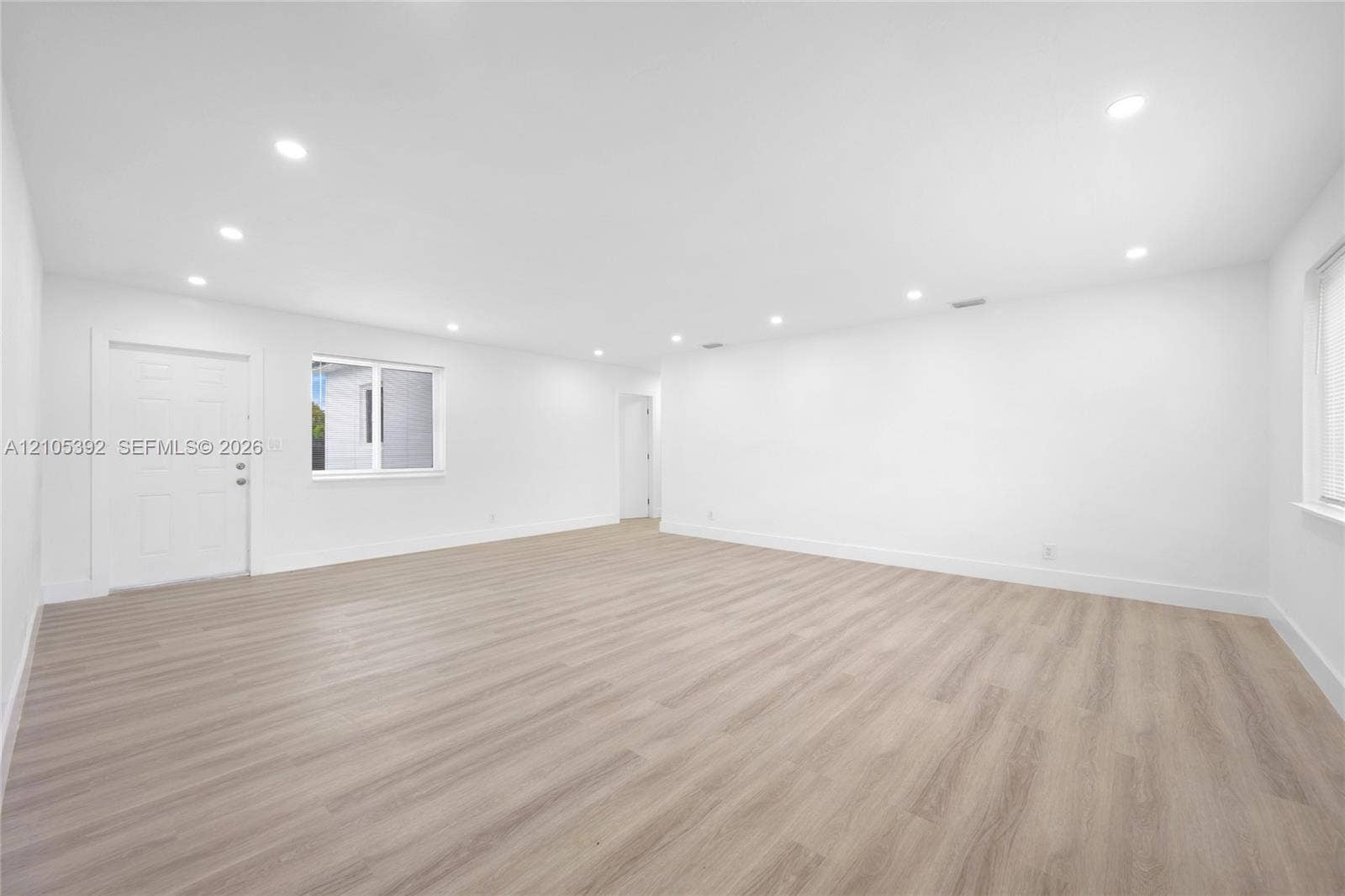 3197 Cleveland Street, Hollywood, FL 33021 Spacious room featuring wood-finish flooring, recessed lighting, and white walls
