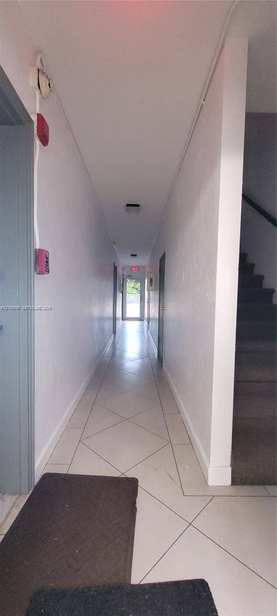 Hallway with tile flooring and painted walls