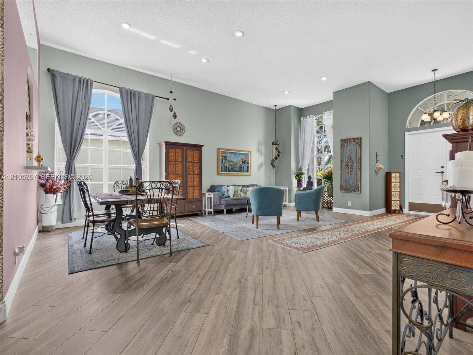 High-ceilinged room featuring ample living and dining space